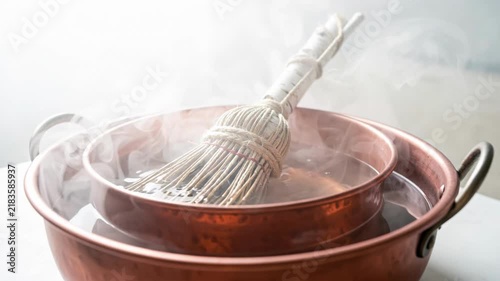 Copper Pot Steaming With Whisk in Kitchen.