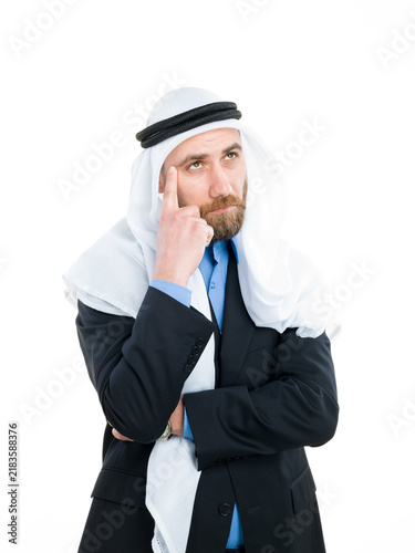 Fotografie Thoughtful Arab businessman wearing keffiyeh thinking and looking up isolated on white background