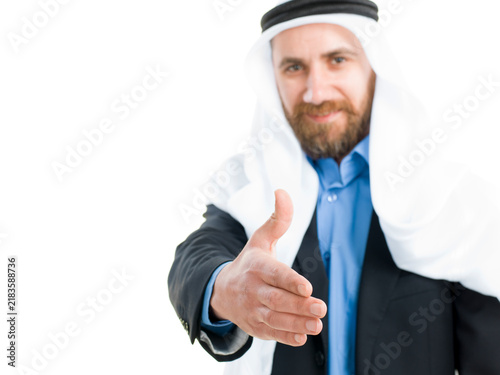 Obraz na płótnie Arab businessman wearing keffiyeh offering hand for a handshake isolated on white background