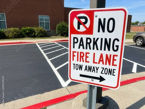 No Parking Fire Lane Tow Away Zone Sign Against Building Background
