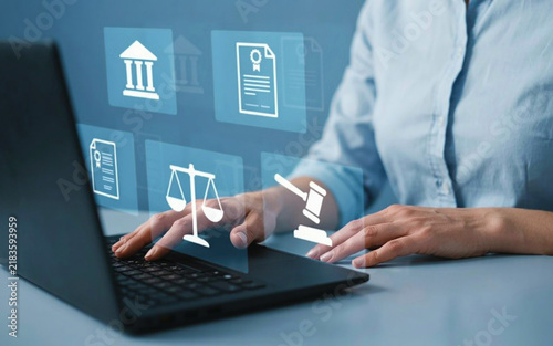 Lawyer working on laptop with legal icons floating above desk for case research.