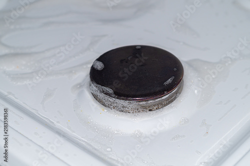 Photography Gas stove surface with sprayed cleaning agent to pre-dissolve dirt