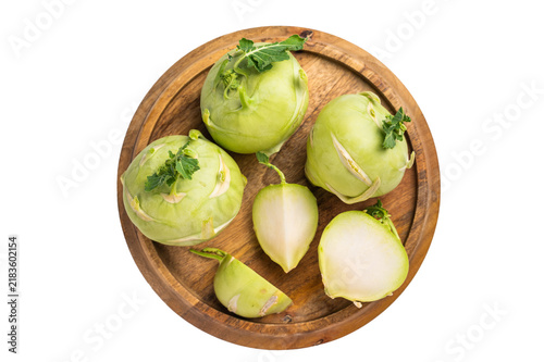 Konstfotografi Raw kohlrabi sliced on pieces on wooden tray isolated on white backround