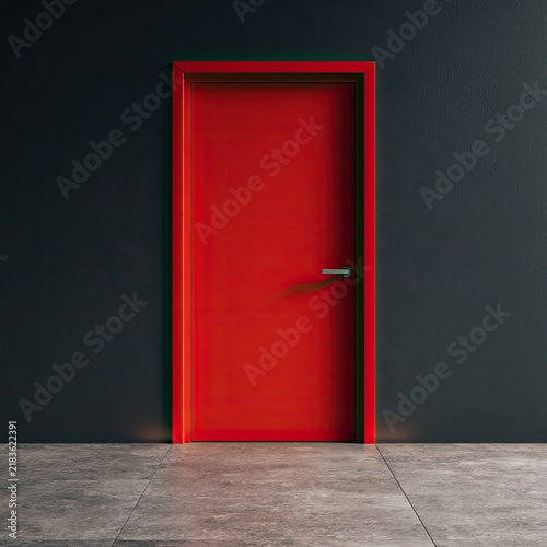 A bright red door stands out against a dark gray wall, with a concrete floor