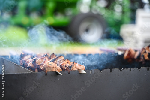 Fresh meat and food in the foreground with agricultural machinery in the background, representing the connection between farming, food production, livestock agriculture, and modern agricultural techno