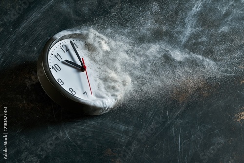 Time is running out concept shows clock that is dissolving away into little particles