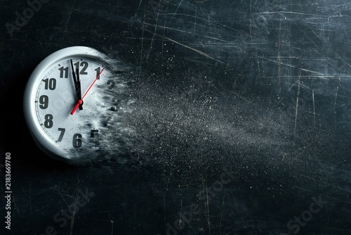 Time is running out concept shows clock that is dissolving away into little particles