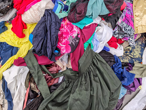 Фотография a large, mixed pile of discarded and unorganized clothing and textiles