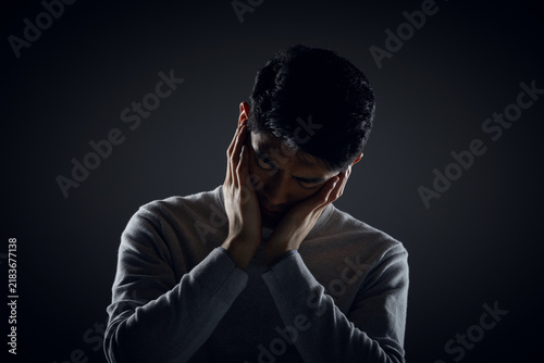 Фотография Sad Man Holding Face in Melancholy Pose