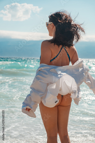 Woman in swimsuit walking on Croatia beach