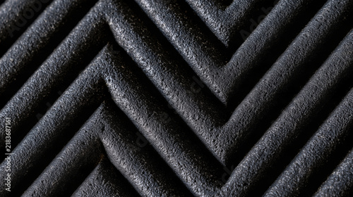 Black rubber car floor mat textured with zigzag pattern  