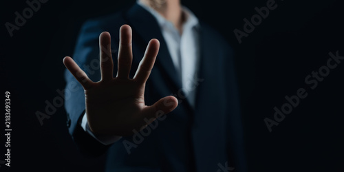 Cuadro en lienzo Business professional raising an open hand in a stop gesture, symbolizing warning, rejection, refusal, prevention, boundaries, caution, security, control, and risk management