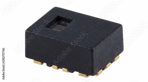 Small black electronic proximity sensor component featuring golden contact pins captured on a plain white background with professional studio lighting