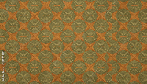 Geometric pattern with repeating circular shapes featuring orange and green star-like designs arranged in a textured grid
