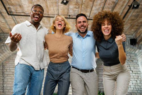 Obraz na płótnie Diverse office team of friends and colleagues celebrating success with smiles an