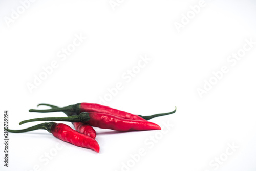 Fresh red chili peppers on clean surface