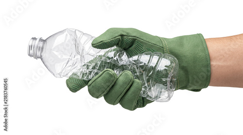 Fotografie Gloved hand crushing plastic water bottle for recycling