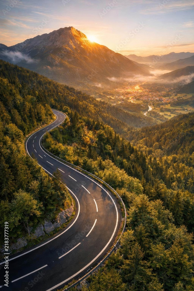 Obraz premium Winding mountain road at sunrise in the Alps.