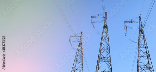 Quadro su tela Electricity pylons transmitting power across the landscape, representing energy