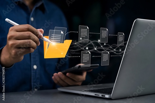 Hand holding orange juice glass near laptop displaying digital network flow and code structure