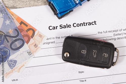 Car sale contract, euro banknotes, blue toy car and black key. Sales, purchases of vehicle