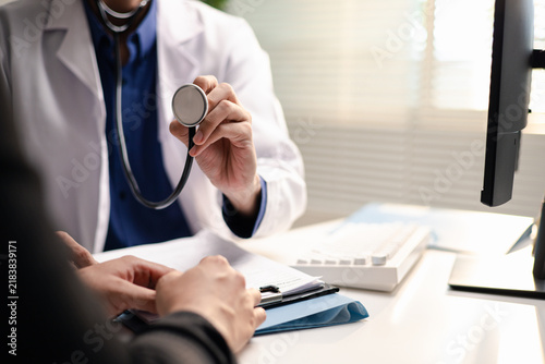 фотографія Doctor consults a patient with a stethoscope in a medical office