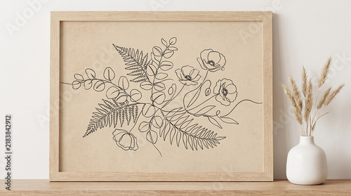 Floral line art botanical print in wood frame with dried grass vase for minimal wall decor.