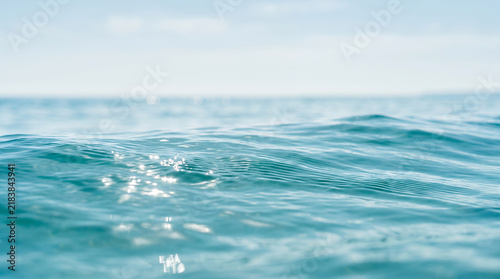 Ocean sea surface water texture with ripples and gentle sunlight reflection for background.