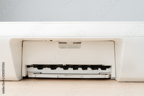 Close-Up Of White Office Printer Paper Tray And Output Slot On Wooden Desk Minimalist