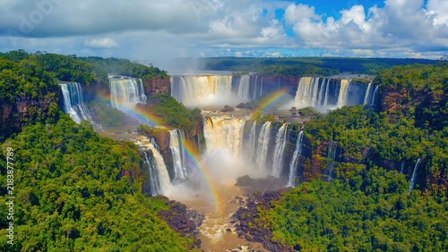 Panoramic Iguazu waterfalls with rainbow mist