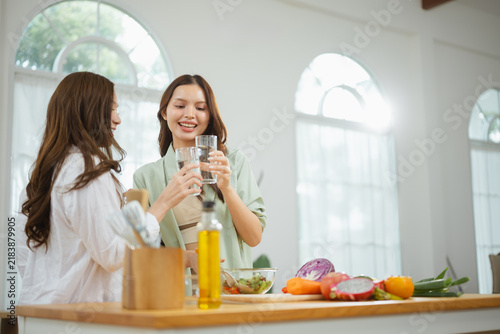 Obraz na płótnie Two glasses held aloft suggest drinking as water supports hydration in a healthy drinking water setting, while smiles suggest drinking as water supports hydration in a healthy drinking water context