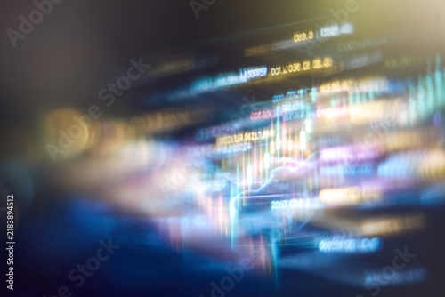 Blurred abstract financial market data and fintech trading charts with glowing digital lights