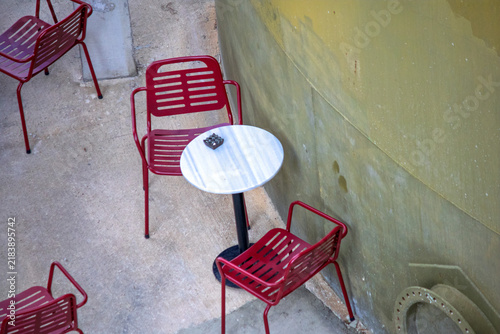 The café's outdoor seating area. Empty tables and chairs. Cafe or restaurant concept. Top view, above, up. No people, nobody. Horizontal photo.
