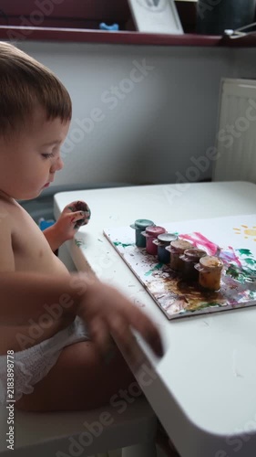 Toddler playing with colorful toys at table
