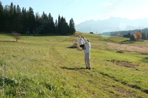 Father and child exploring meadow