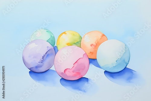 Watercolor painting of colorful round spheres with soft shadows on pale blue paper background