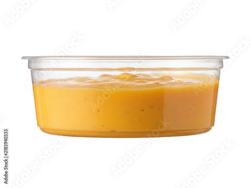 Cheese dip isolated on a transparent or white background. Tasty movie theatre snack portion, delicious cinema fast food concept and traditional yellow sauce for nachos.
