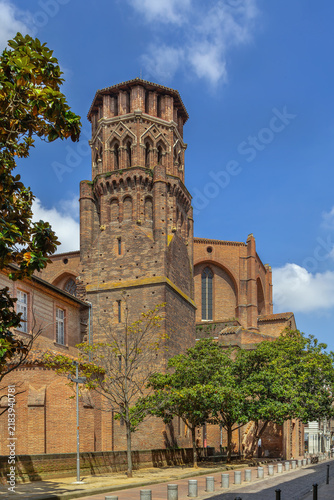 Low angle view of Augustinian Convent bell tower in Toulouse, France. Southern Gothic brick tower under blue sky