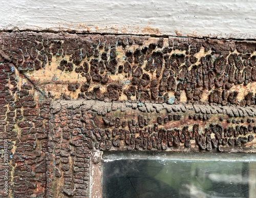 Horizontal flat lay background texture of old wood window frame with heavily peeling cracked brown paint