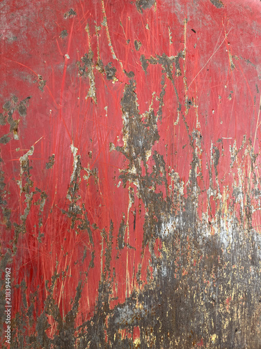 Full frame texture of old rusty red painted metal sheet with heavy corrosion and scratches.