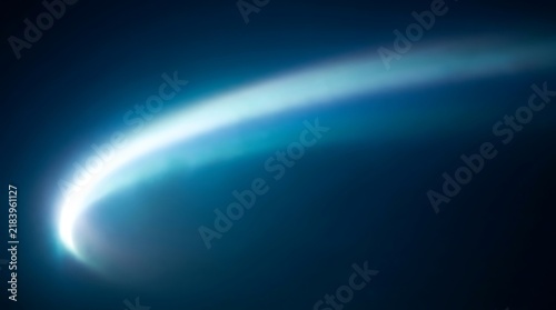Vibrant blue curved light trail with subtle wisps on dark background, abstract motion effect