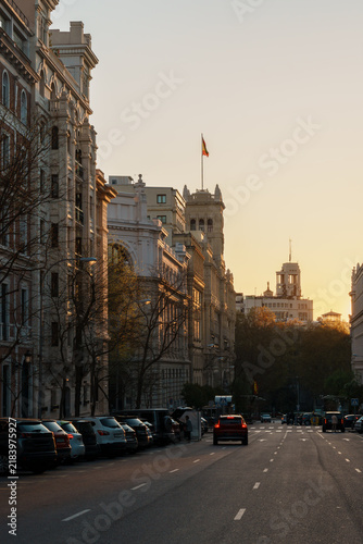 Street view toward Metropolis building at sunset