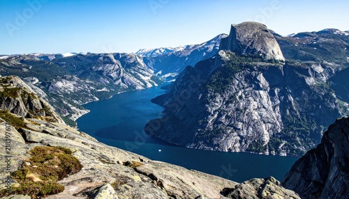 Majestic Norwegian Fjords with Towering Mountains and Deep Blue Water Under a Clear Sky