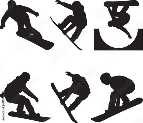Silhouetted snowboarders in winter snow landscape at sunset