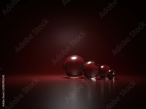 Four Transparent Glass Spheres Arranged By Size On A Dark Red Background