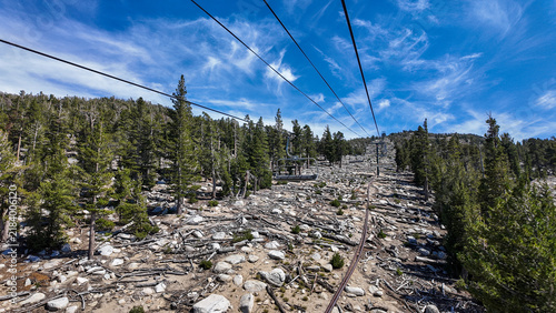 A Ski Lift looking at the top of the mountain with transport cable seats and support in the Summer os tuorists can go to the top of the mountain