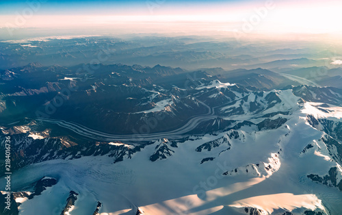 Aerial view of snow mountain and frozen river in colorful morning sunlight in Alaska