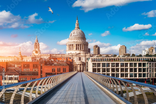 St Pauls Cathedral and Millennium Bridge, London, UK, historic dome framed by modern cityscape on the River Thames, England, Europe