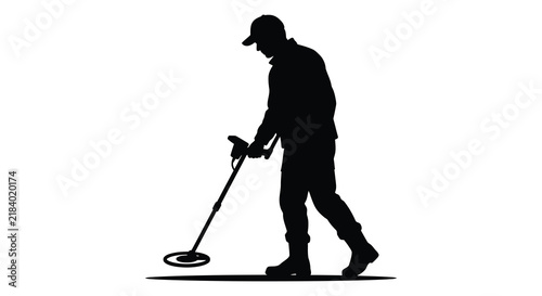 Bild auf Leinwand Man operating a metal detector in a black silhouette
