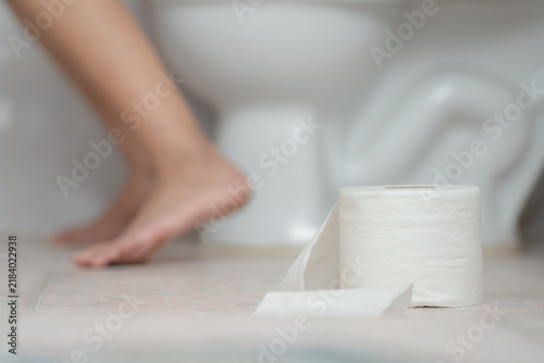 Canvastavla Constipation and diarrhea concept, woman sitting on toilet holding tissue paper